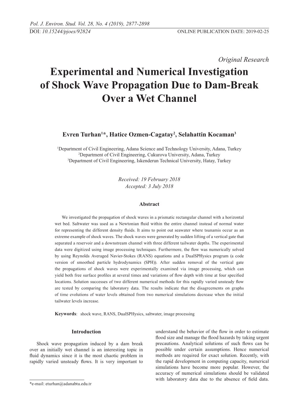 Experimental and Numerical Investigation of Shock Wave Propagation Due to Dam-Break Over a Wet Channel