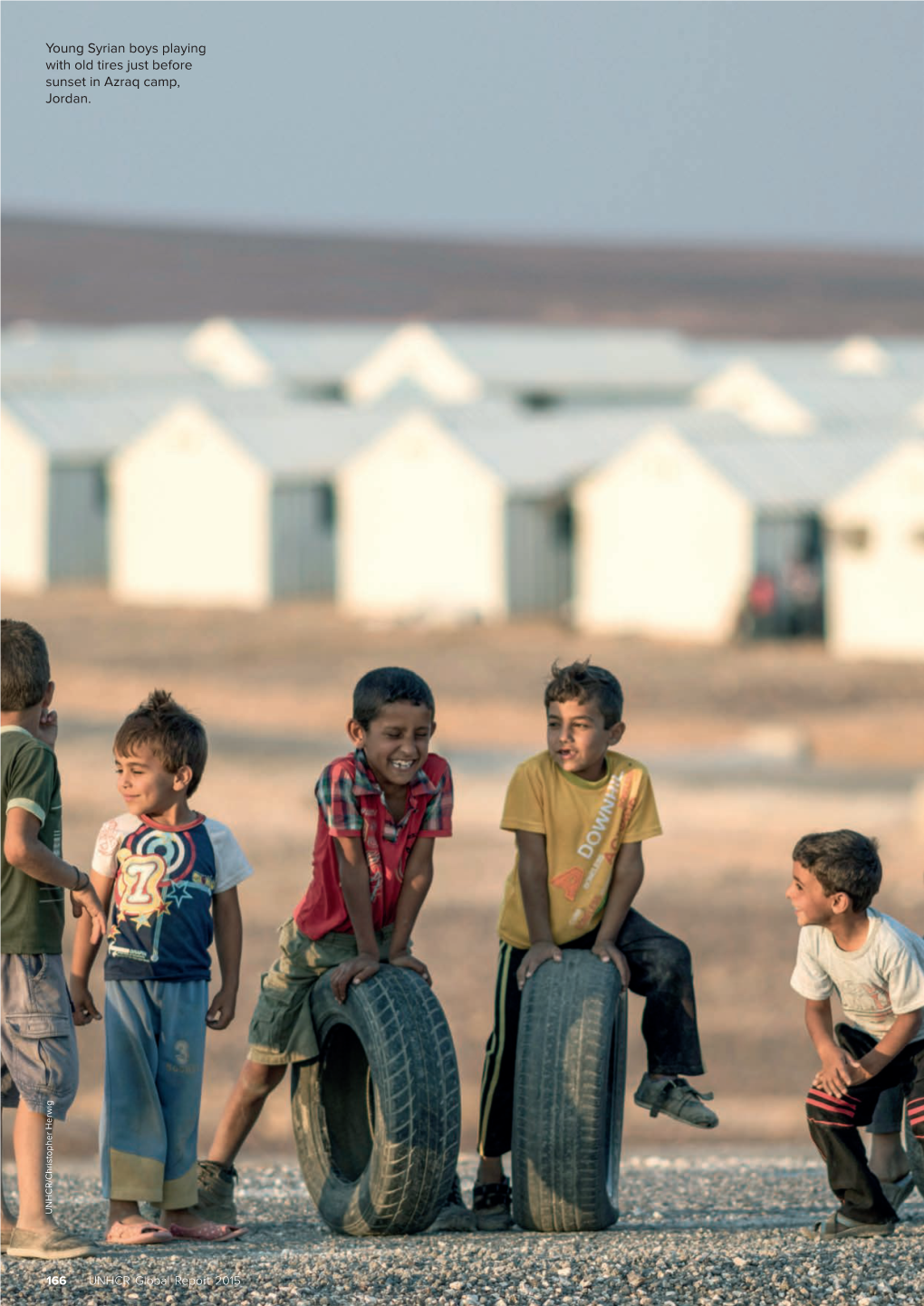 Young Syrian Boys Playing with Old Tires Just Before Sunset in Azraq Camp, Jordan
