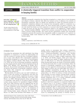 A Chemically Triggered Transition from Conflict to Cooperation in Burying