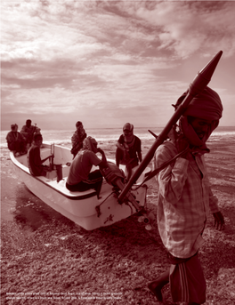 Members of the Pirate Group Central Regional Coast Guard, One of Whom Carries a Rocket-Propelled Grenade Launcher, Arrive on a Beach Near Hobyo, October 2008