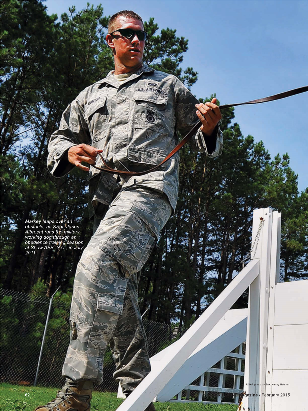 Markey Leaps Over an Obstacle, As Ssgt. Jason Albrecht Runs the Military Working Dog Through an Obedience Training Session at Shaw AFB, S.C., in July 2011